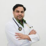Portrait of a confident male doctor in a clinic environment, wearing a lab coat and stethoscope.